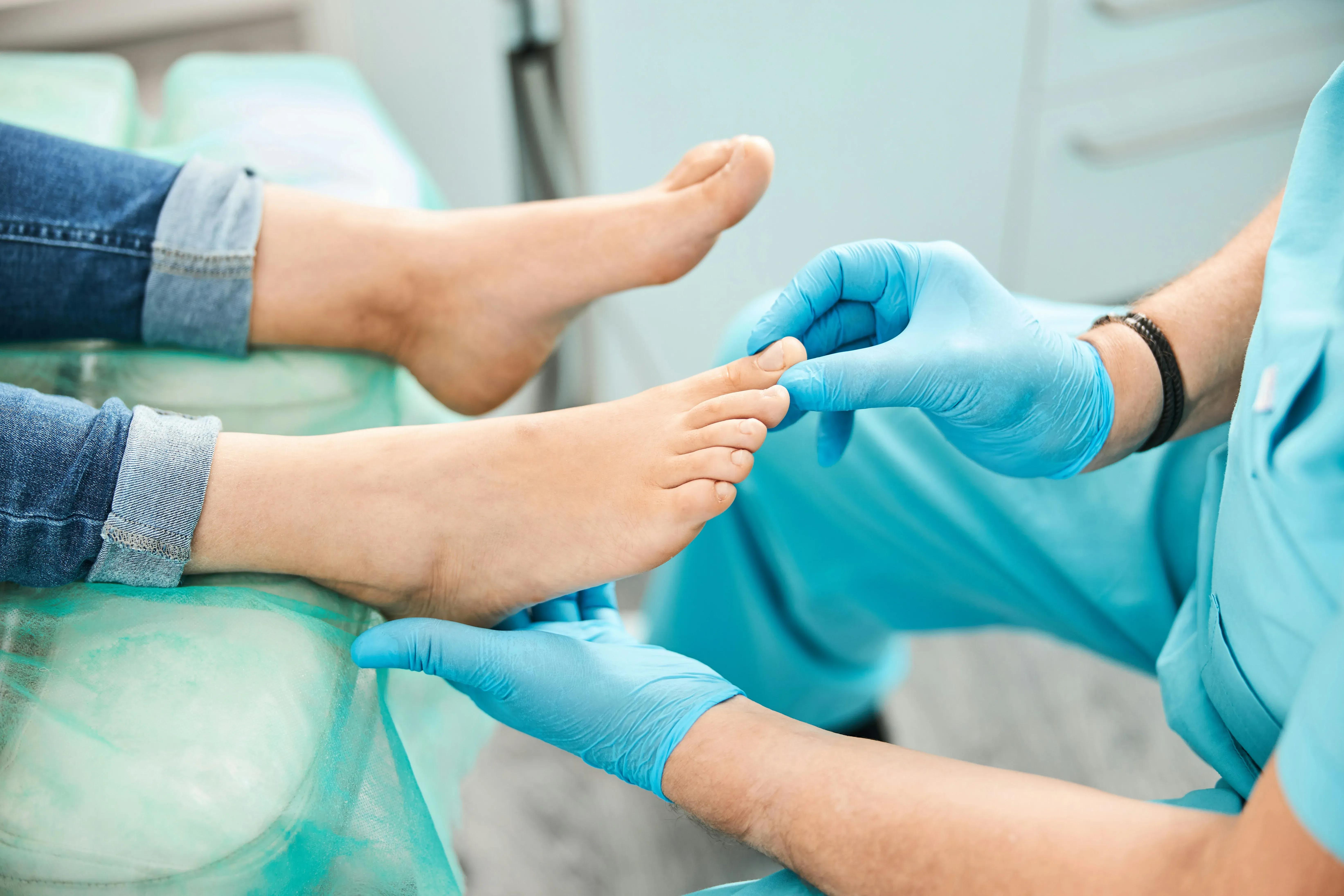 A podiatrist examining a patient's foot during a first visit